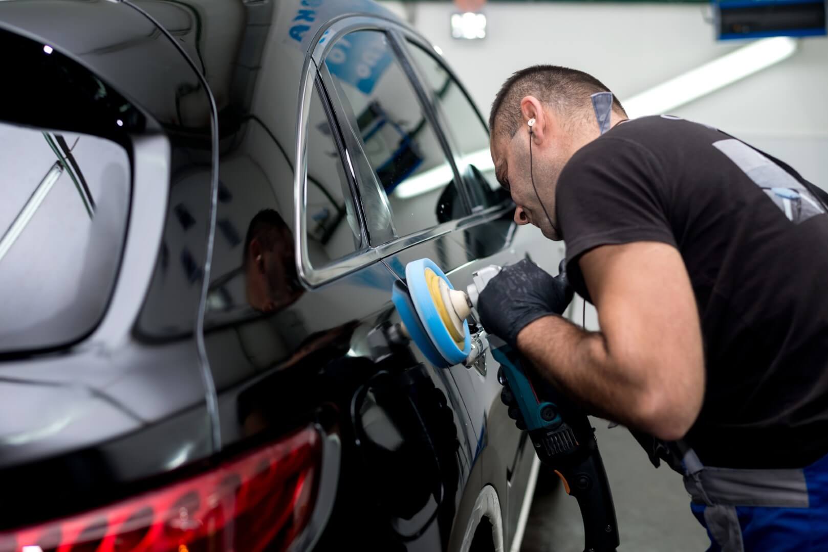 Car detailing expert from Forest Hill waxing a car.